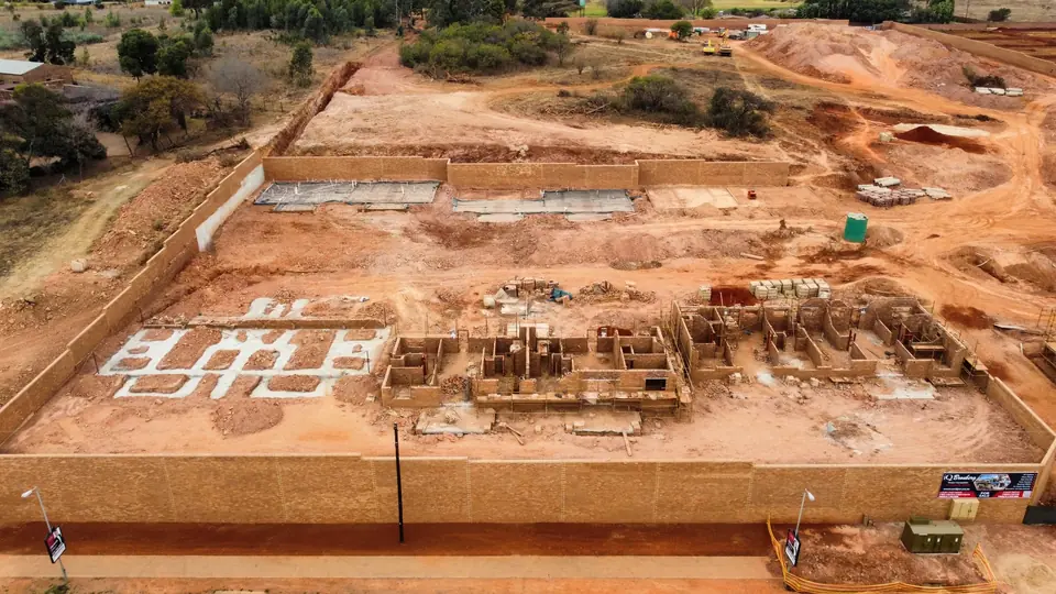 Aerial overview showing foundations, masonry and current building activity at iQ Bronberg