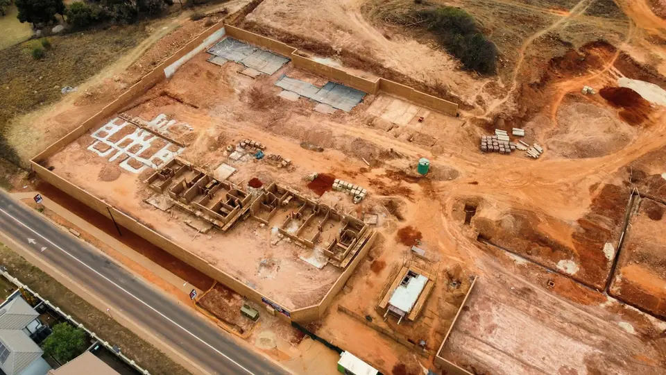 Oblique drone view showing current foundations, masonry and slab works at iQ Bronberg