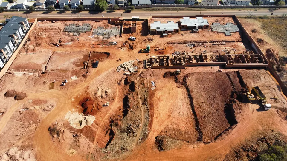High aerial overview of active construction across the iQ Bronberg site