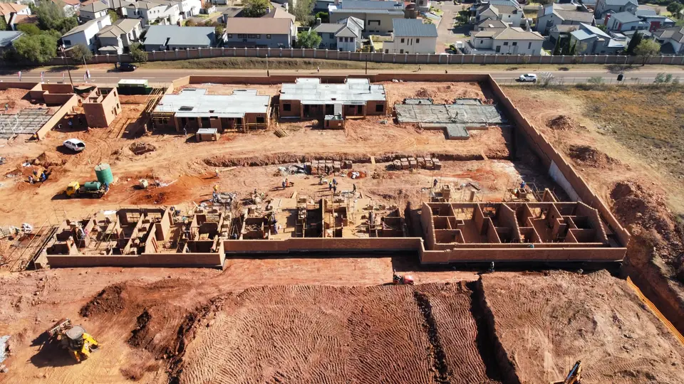 Aerial view of new masonry taking shape along the Phase 1 blocks